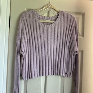Purple cropped sweater with ribbed knit and long sleeves.